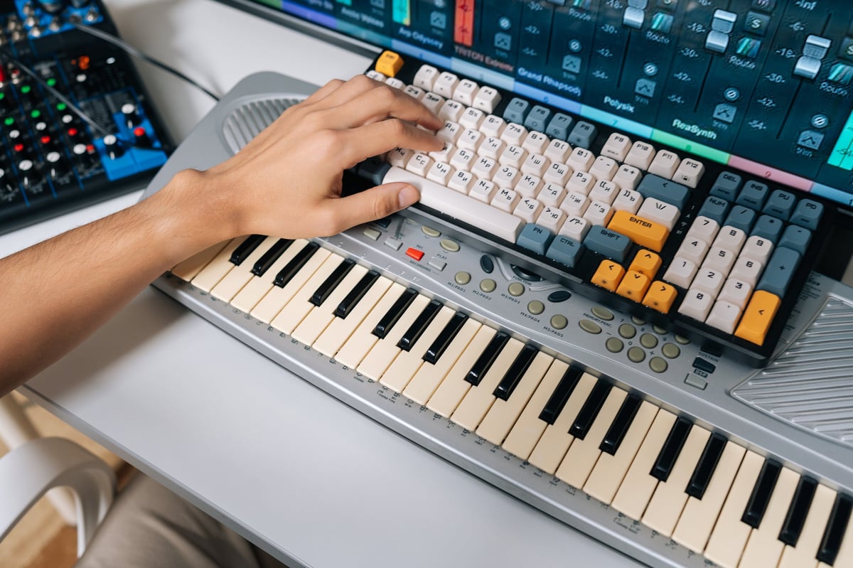 Musician working with audio equipment and a keyboard